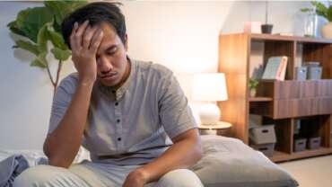 Sleepy tired man dreaming, sleeping at home early in the morning due to not getting enough sleep