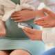 A pregnant woman with gestational diabetes mellitus checking her blood sugar level by using digital glucose meter in hospital