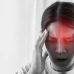 A dizzy Asian woman holding head, experiencing a headache, and seeking for treatment