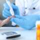 A pharmacist in pharmacy determines blood glucose level for insulin determination in a patient with diabetes