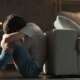 A sad and depressed teenager boy sitting on the floor, a concept of depression
