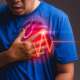 Man suffering from chest pain having heart attack or painful cramps