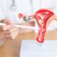A doctor in a white coat checks for cervical cancer risk factors