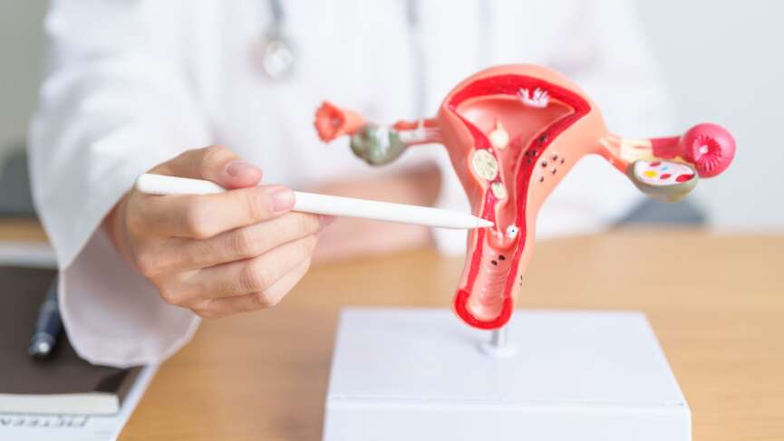 A doctor in a white coat checks for cervical cancer