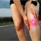 Sports injury woman and knee with red glow outdoors, holding leg, ACL tear pain