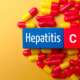 Top view of a medical pill and colored cube with the word hepatitis C medical concept
