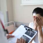 Desperate woman hearing the results of a pregnancy test and signs of infertility