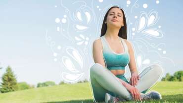 A fresh woman goes for a walk at the park, sits on the grass, and rejoices