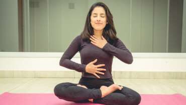 A woman in a yoga pose performing gut health exercise