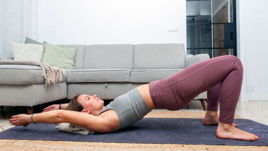 fitness athlete performing piriformis stretches for pain relief indoors