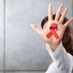 female with red ribbon for AIDS/HIV awareness