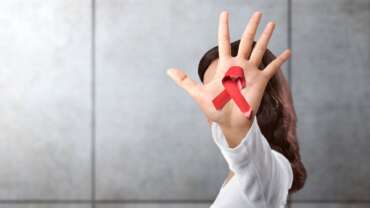 female with red ribbon for AIDS/HIV awareness