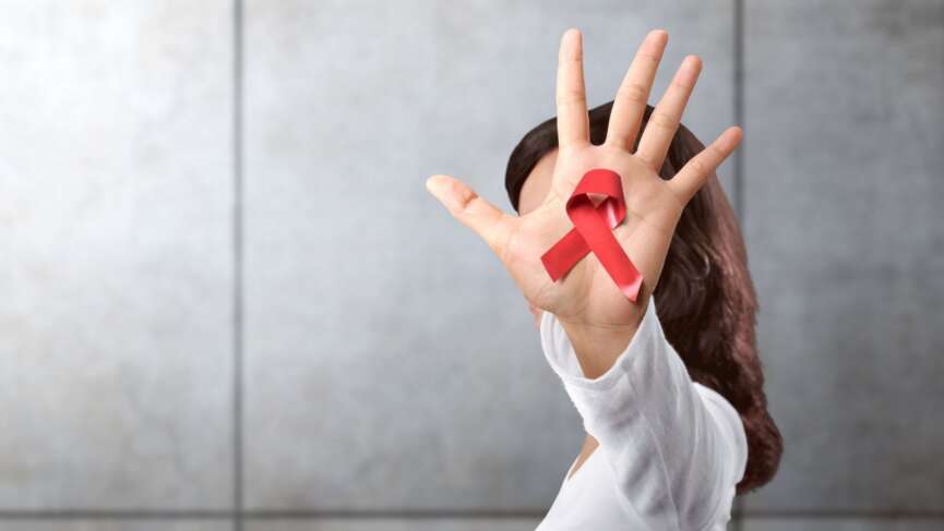 female with red ribbon for AIDS/HIV awareness