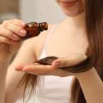 A woman applying hair oil for hair growth