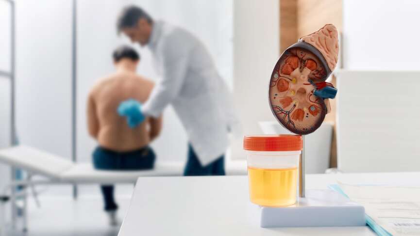 a doctor checking patient in background with a blurry affect representing anemia in kidney disease