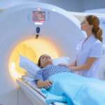 Patient comforted during mri scan for radiation therapy for breast cancer