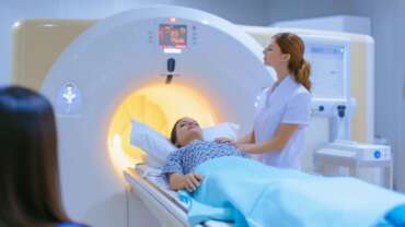 Patient comforted during mri scan for radiation therapy for breast cancer