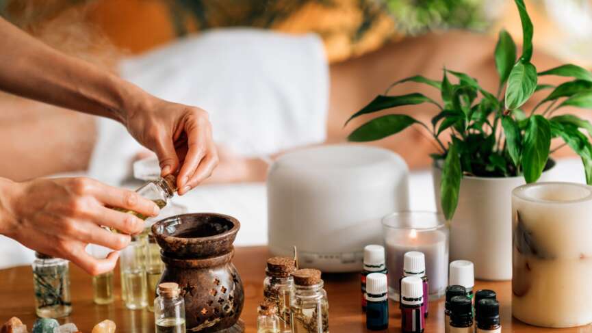Ayurvedic aromatherapy massage, pouring aromatic oil in essential oil diffuser and benefits of aromatherapy