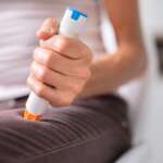 A girl holding an injection or syringe for anaphylaxis emergency response