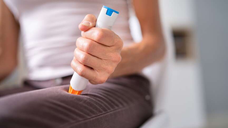 A girl holding an injection or syringe for anaphylaxis emergency response