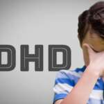 Young boy with dense hair and sad mood representing adhd and childhood challenges and adhd causes