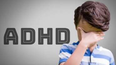 Young boy with dense hair and sad mood representing adhd and childhood challenges and adhd causes