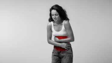 Young woman suffering from abdominal pain due to heavy menstrual bleeding