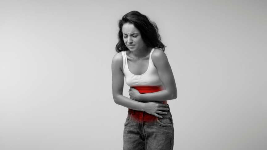 Young woman suffering from abdominal pain due to heavy menstrual bleeding