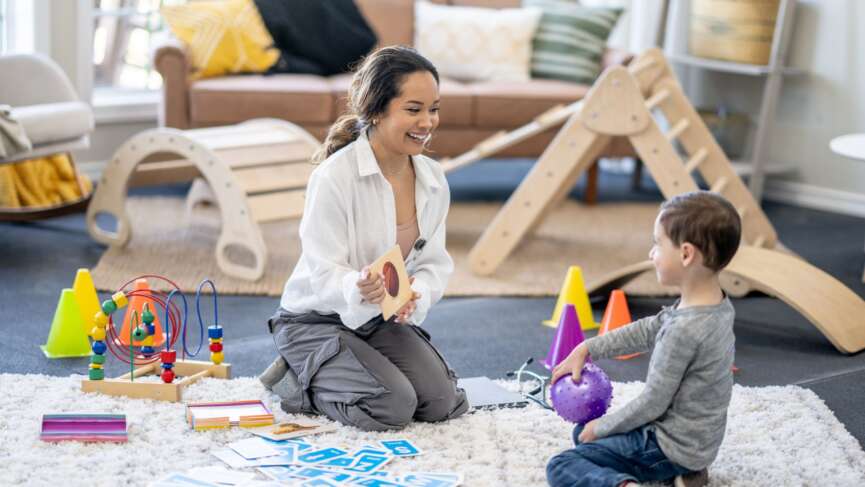 mother performing ABA therapy for her autism son