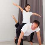 father and kid exercising at home