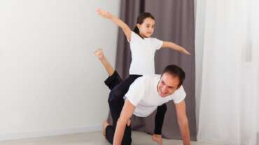 father and kid exercising at home