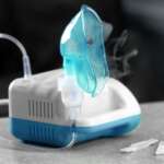 Compressor nebulizer/oxygen therapy with mask on table for the treatment of COPD