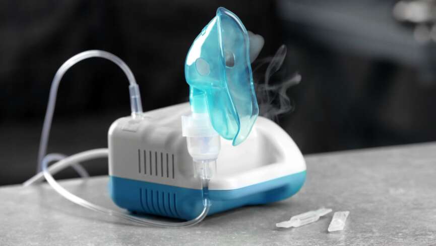 Compressor nebulizer/oxygen therapy with mask on table for the treatment of COPD