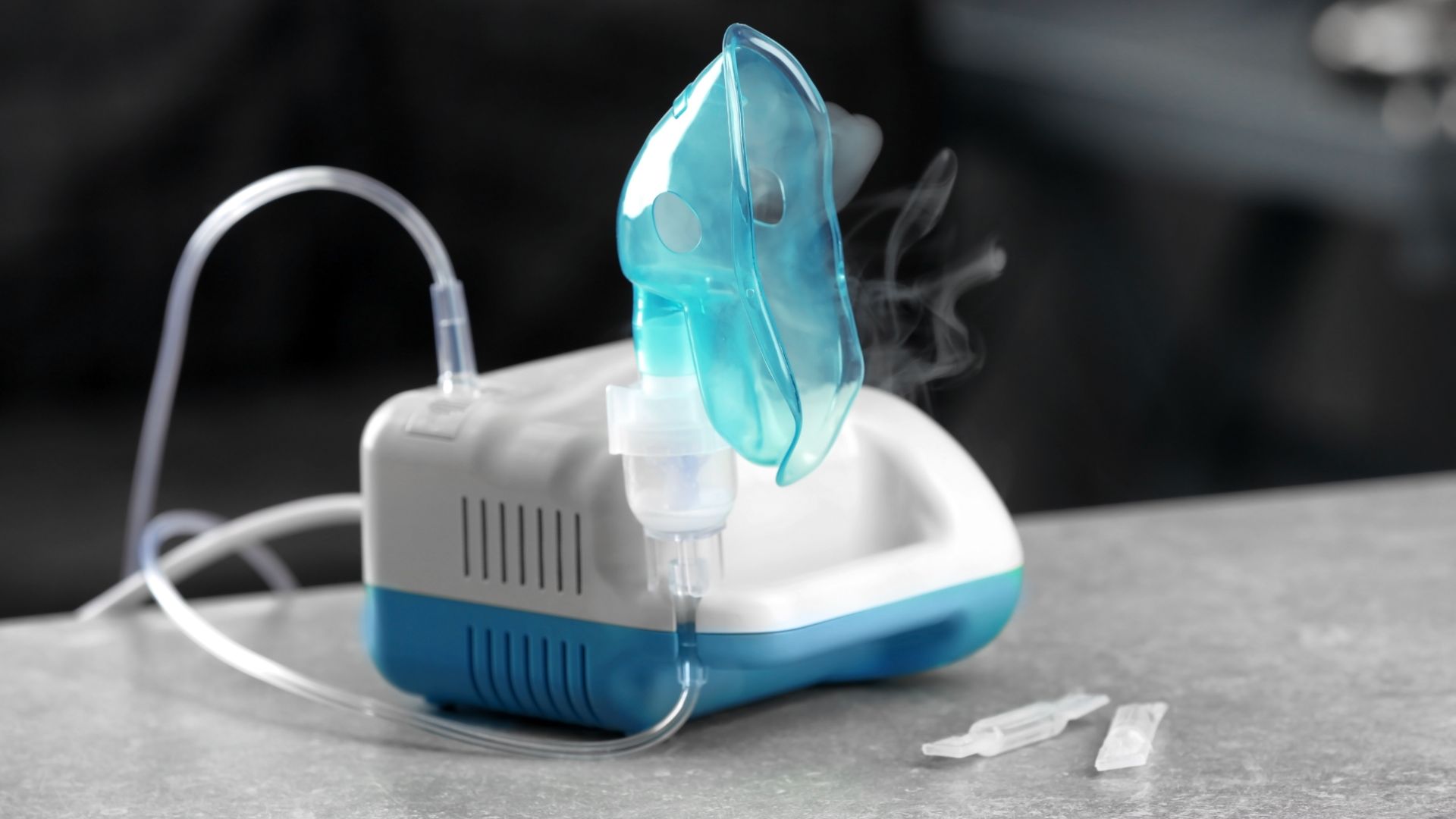 Compressor nebulizer/oxygen therapy with mask on table for the treatment of COPD