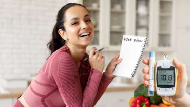a beautiful women planning her meal strategies for diabetes control and a glucometer device on the side