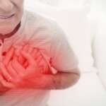 Old man clutching chest with red highlight suggesting heart attack or symptoms of heart attack
