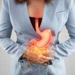 A woman holding stomach in pain from gastritis seeking natural remedies