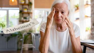 attractive senior woman with alzheimer's disease sitting on table