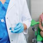 A gynecologist collects a pap smear sample for cervical cancer screening test