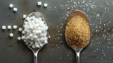 Natural vs Artificial Sweeteners concept displaying in spoon