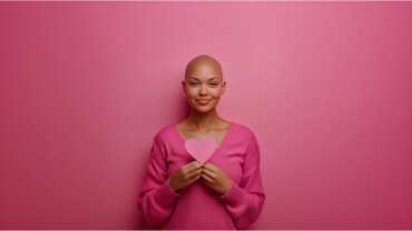 Bald female with breast cancer awareness ribbon