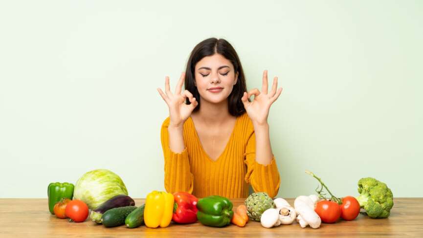Happy girl with various healthy fruits in home kitchen. Reduce inflammation fast concept