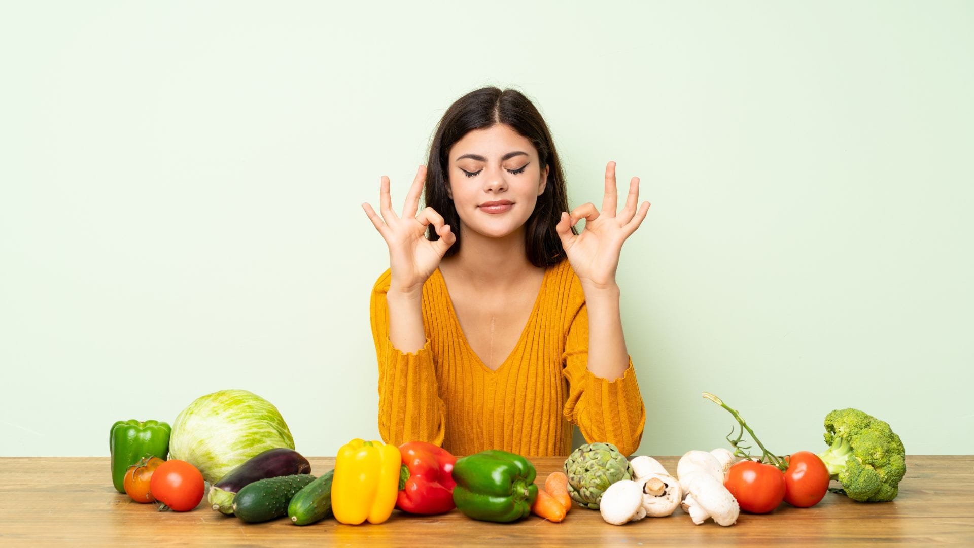 Happy girl with various healthy fruits in home kitchen. Reduce inflammation fast concept