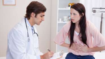 Doctor nutritionist takes a patient with foodborne illness in the office for proper checkup