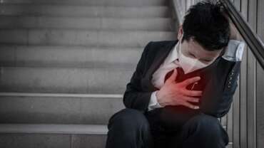 Young man having chest pain and heart health due to stress concept