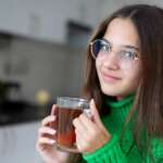 A sensible tea experience of herbal or green tea by a beautiful girl. Health benefits of green tea concept