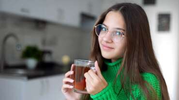 A sensible tea experience of herbal or green tea by a beautiful girl. Health benefits of green tea concept
