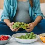 A pregnant woman eating nutritional fruits in bed, representing best foods for fertility