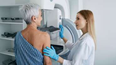 shot of a mature woman being comforted by a doctor before cancer screening and test