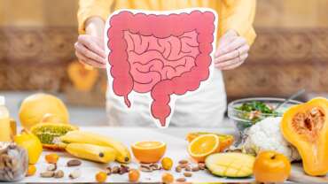 Young woman preparing a healthy meal and foods for gut health